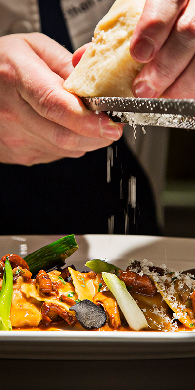 Chef grating parmesan cheese